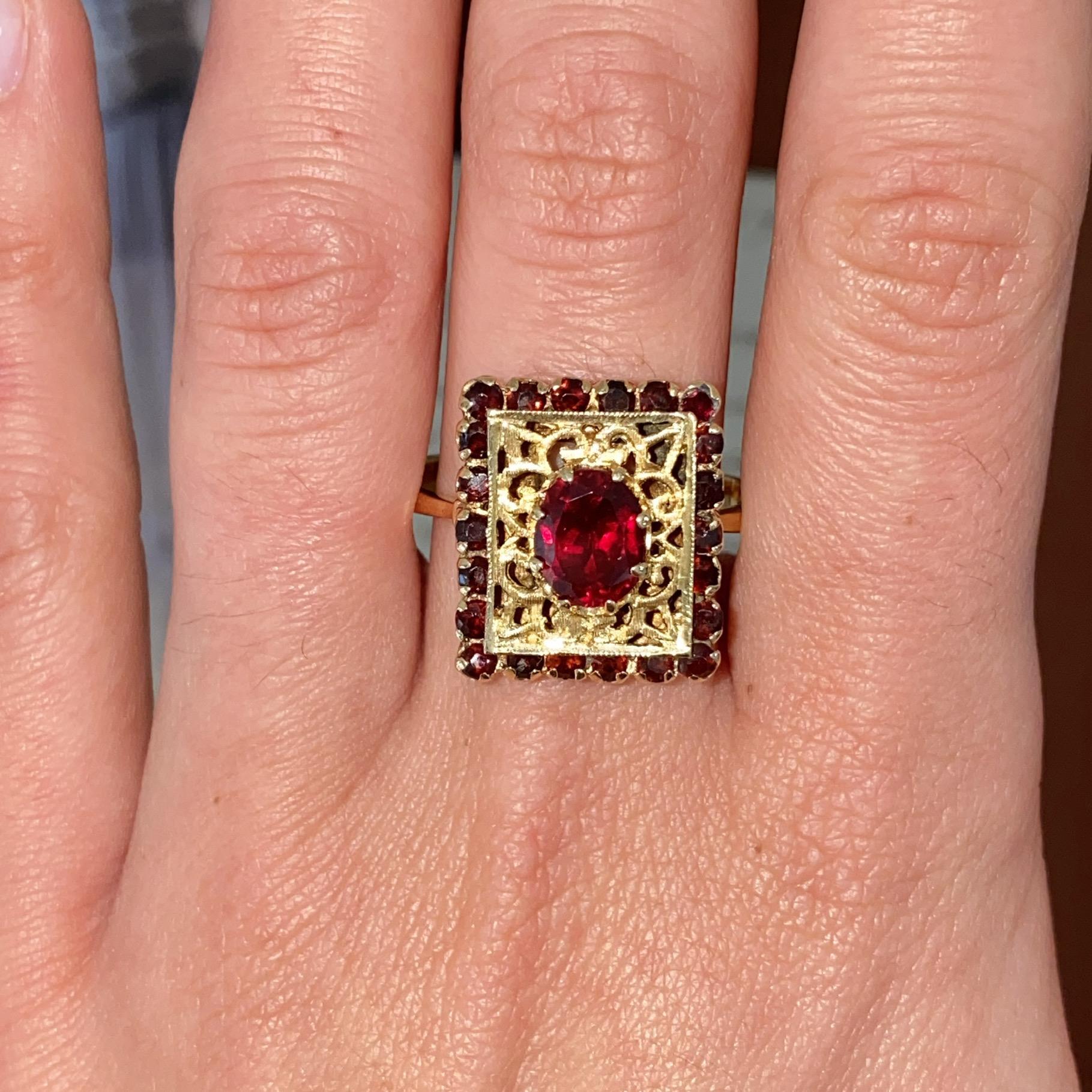 Anello vintage in oro 18kt con granati e decorazioni a traforo