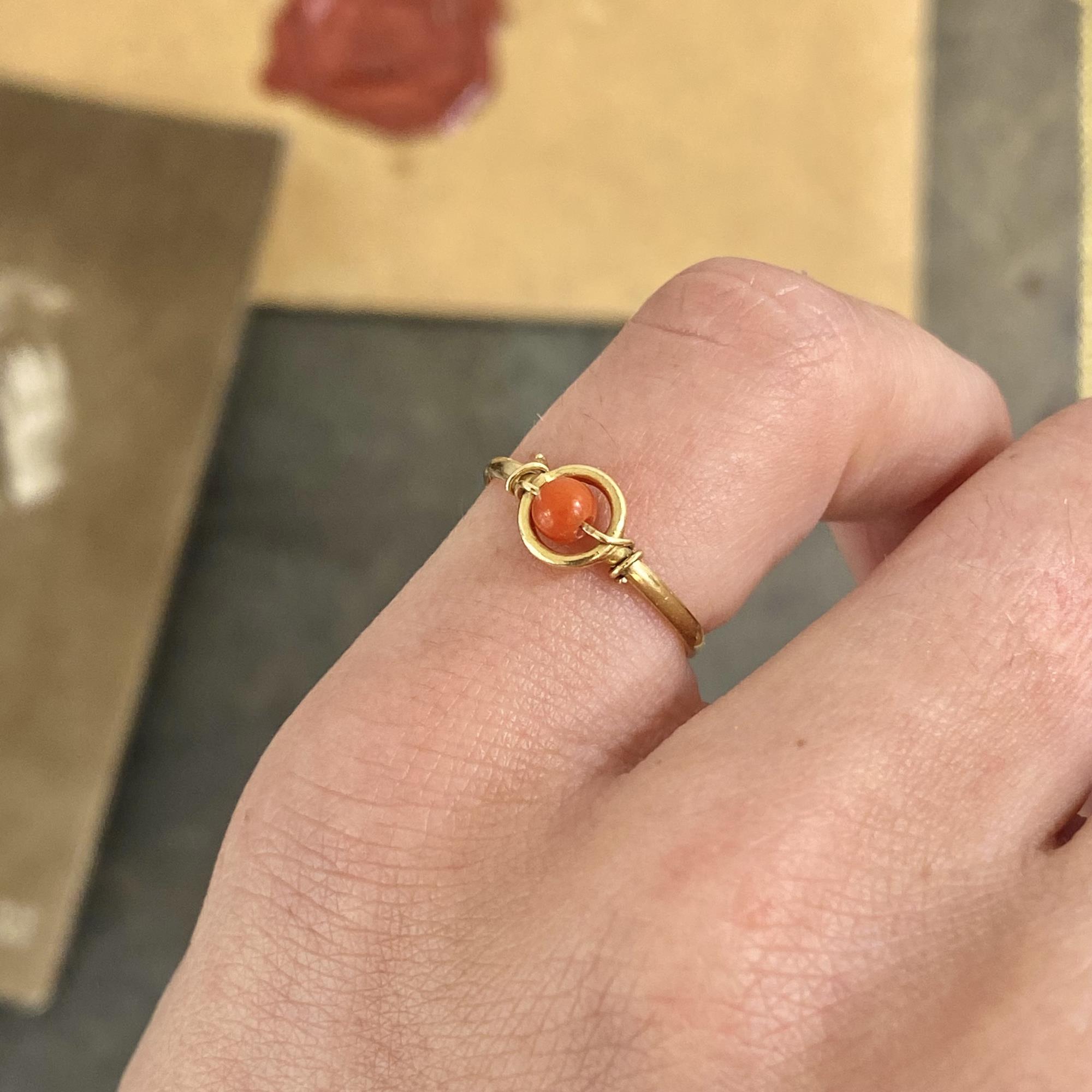 Vintage 18kt gold ring with a small natural coral bead